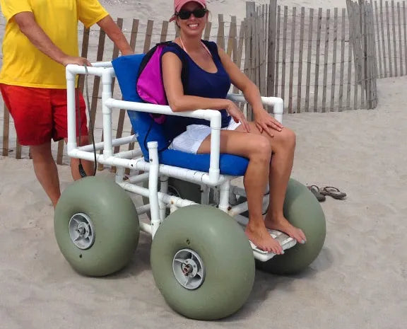Man Pushing A Woman in a AccessRec PVC Beach Wheelchair