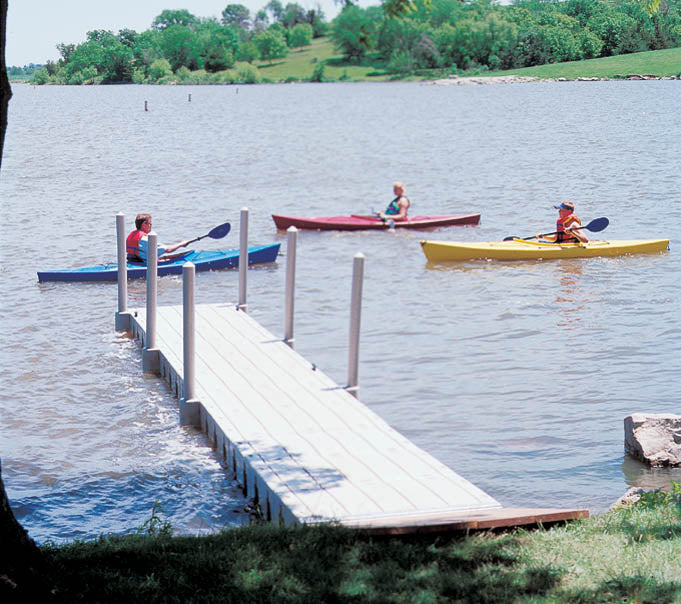 Connect-A-Dock Straight Shape Low-Profile Docks installed in a lake with boaters having fun sailing