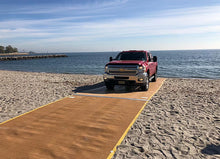 Load image into Gallery viewer, Red Truck Driving Up The Beach On A  AccessRec Mustmove® Vehicle Beach Access Mat