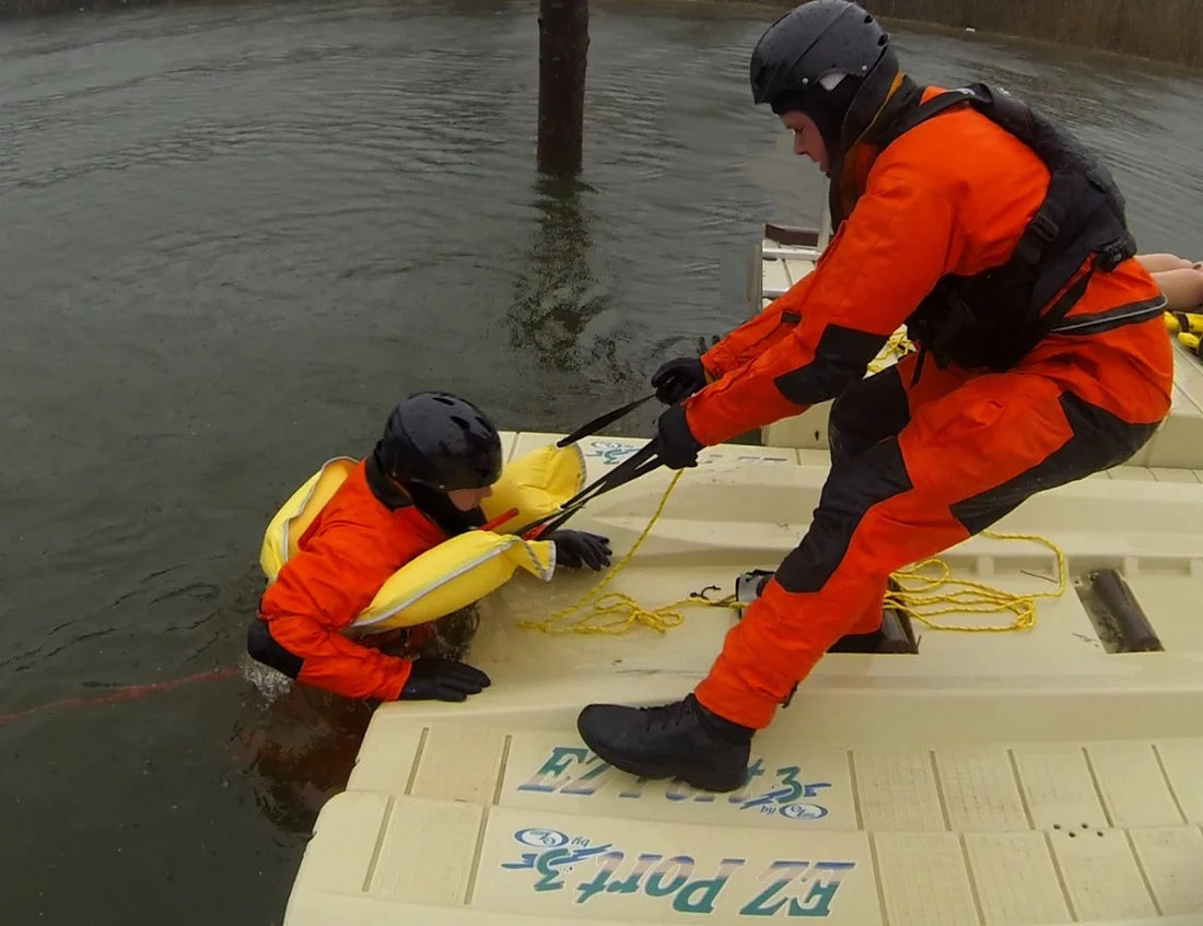 Man pulling the man from the water with the Switlik TechFloat - Inflatable Rescue Device