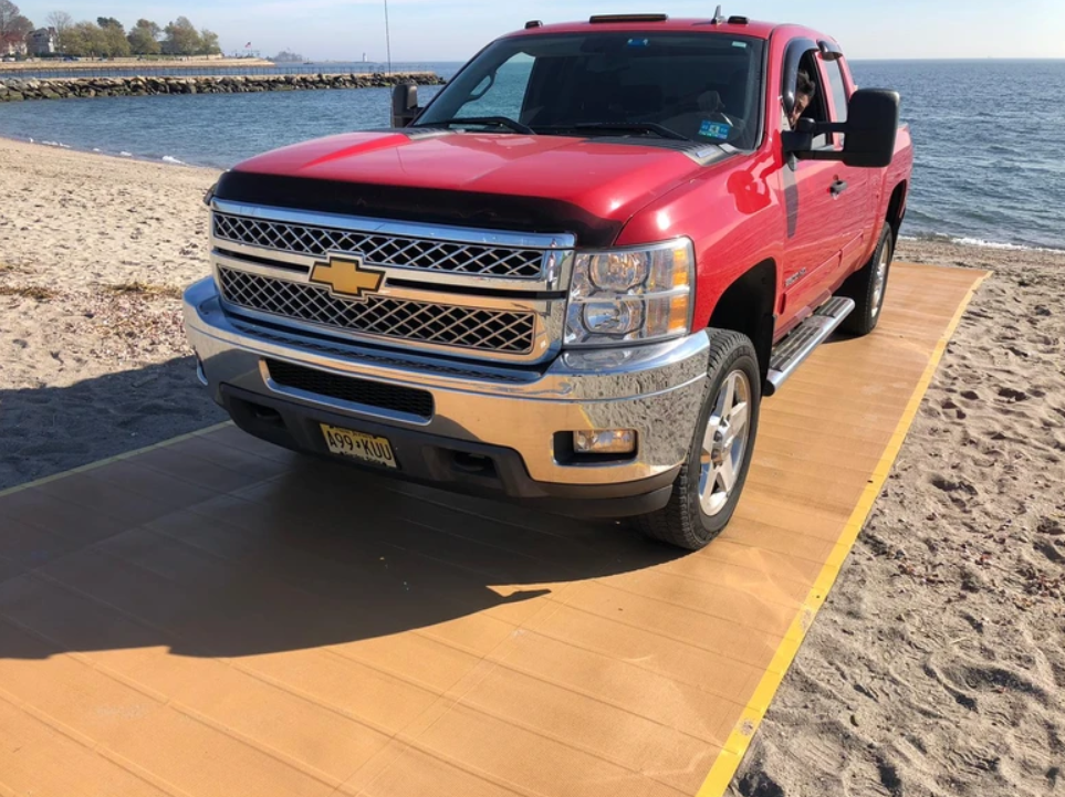 Red Pick-up Truck Coming Out Of The Water on  AccessRec Mustmove® Vehicle Beach Access Mat