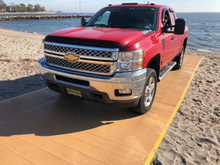 Load image into Gallery viewer, Red Pick-up Truck Coming Out Of The Water on  AccessRec Mustmove® Vehicle Beach Access Mat