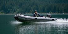 Load image into Gallery viewer, Man riding the Swellfish Classic 430 Inflatable Boat  (14'1")