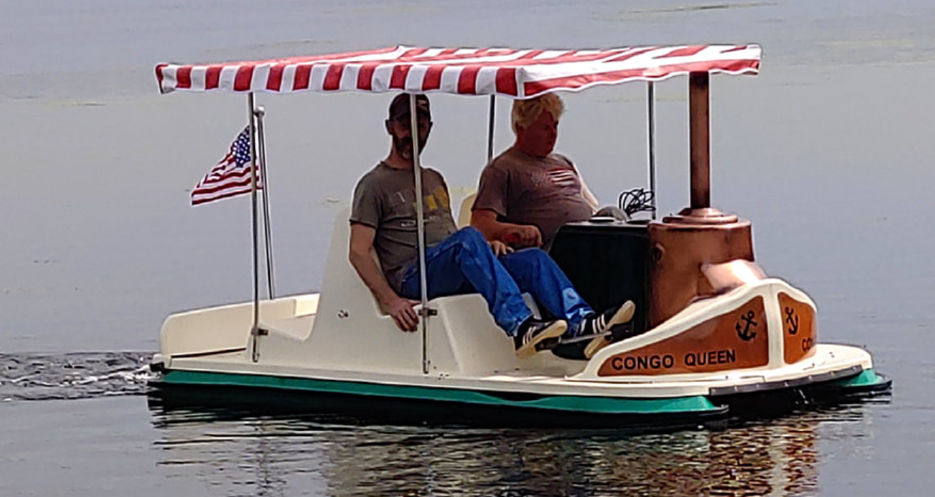 men riding the Adventure Glass Mark Twain African Queen Paddle Boat