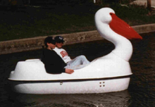Load image into Gallery viewer, Adventure Glass Pelican Classic 2 Person Paddle Boat with two people on board