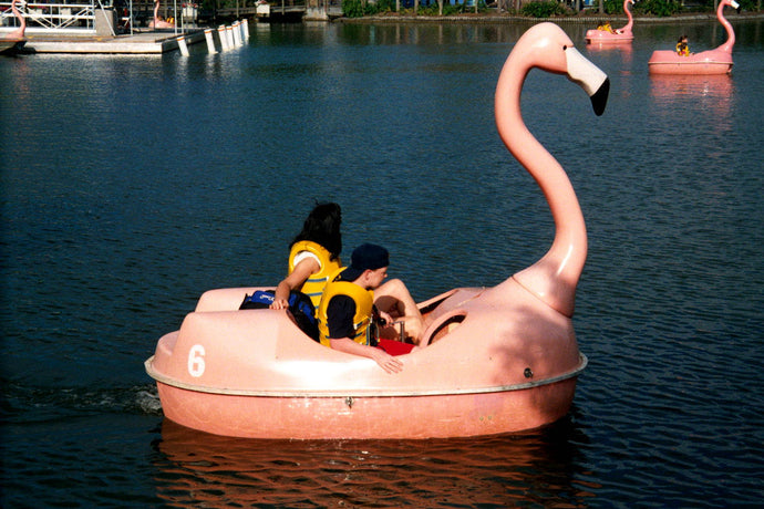 People enjoying the water with the Adventure Glass Pink Flamingo Classic 2 Person Paddle Boat