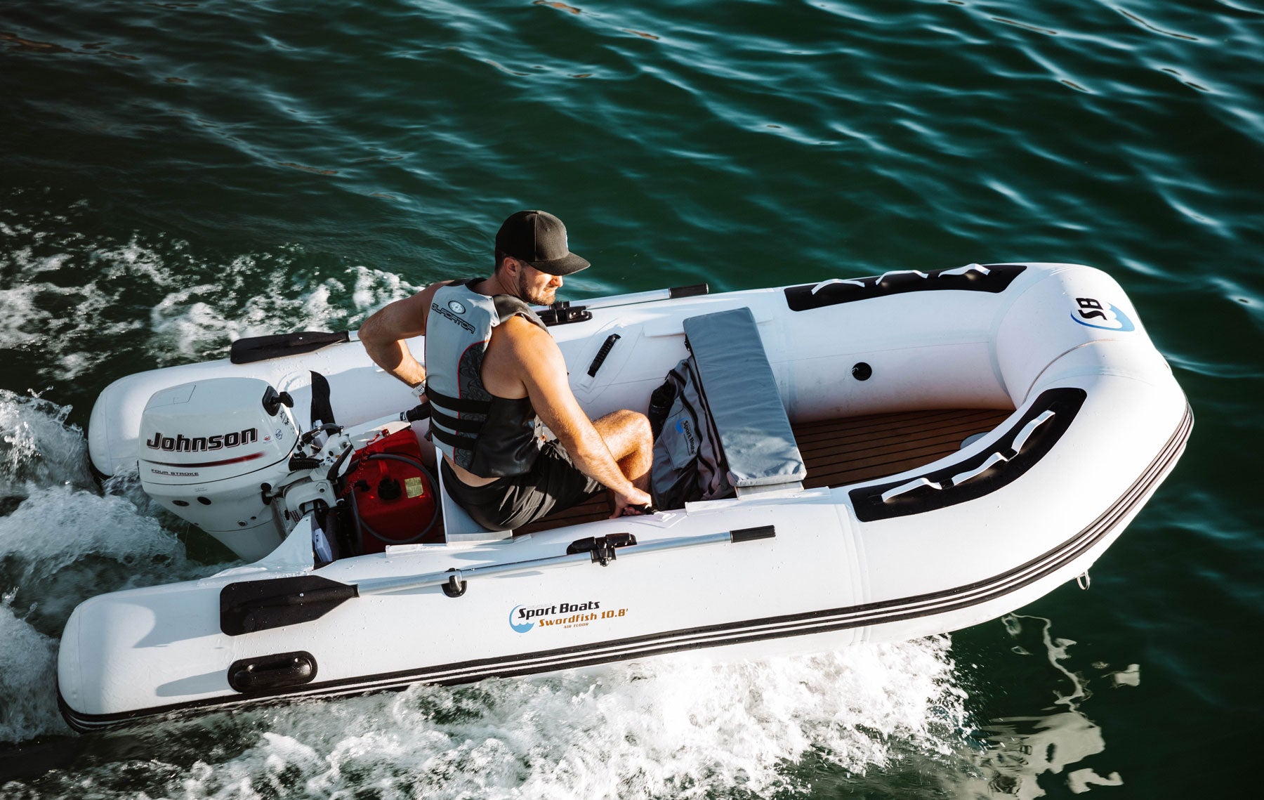 Man At The Helm Of The 10.8' Inflatable Sports Boat Swordfish