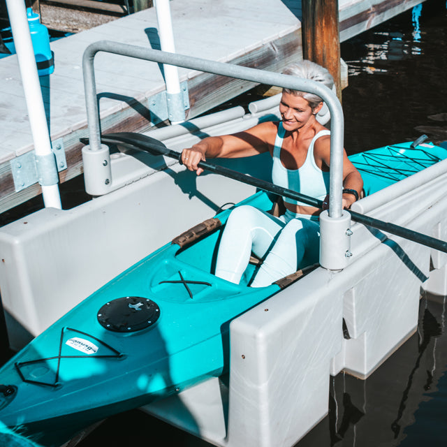 Woman docking her kayak on Connect-A-Dock YAKport® Kayak Launch
