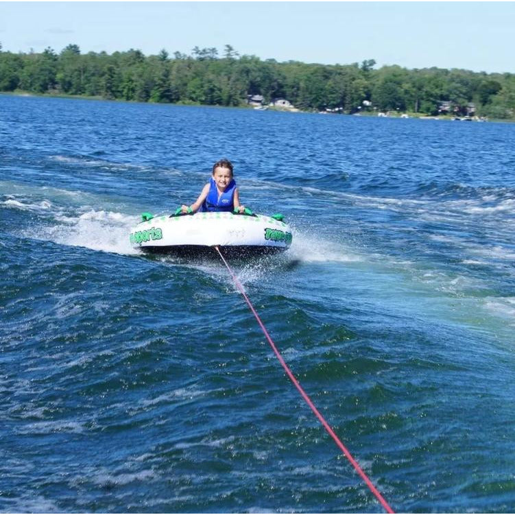 A kid in Rave Sports Frantic 2 Rider Towable 02406