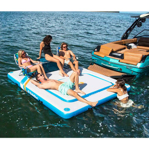 A group of friends chilling on Solstice Watersports 10' X 8' X 8" Inflatable Rec Mesh Dock 38180