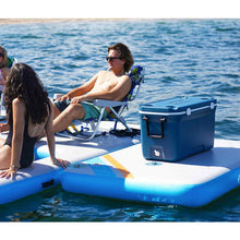 Load image into Gallery viewer, A man and a woman sitting on Solstice Watersports 10&#39; X 8&#39; X 8&quot; Inflatable Rec Mesh Dock 38180