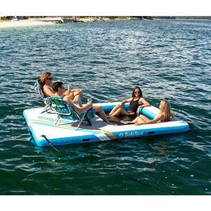A group of friends chilling on Solstice Watersports 10' X 8' X 8" Inflatable Rec Mesh Dock 38180