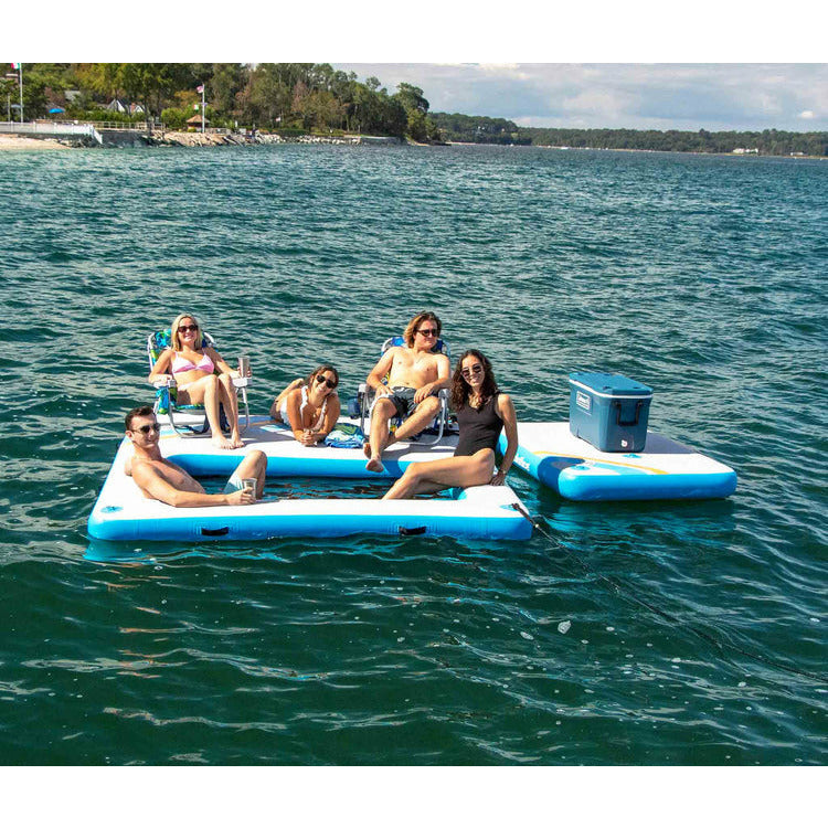A group of friends chilling on Solstice Watersports 10' X 8' X 8" Inflatable Rec Mesh Dock 38180