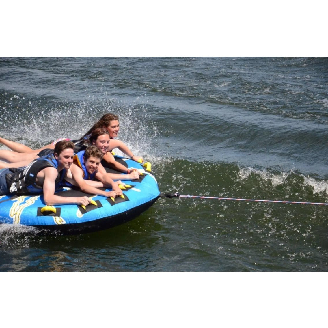 4 people enjoying Rave Sports Mega Storm 4 Rider Towable 02325
