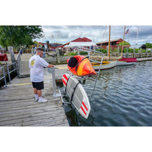 Load image into Gallery viewer, Man operating the Seahorse Docking Floating Dock Double Kayak Launch And Stow with kayak and paddle board in it.