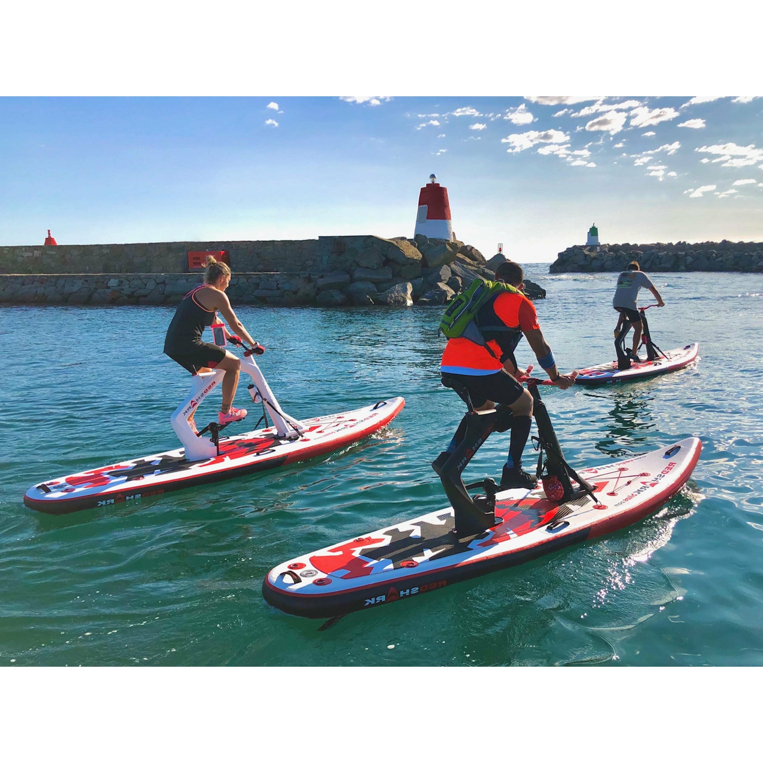 Three People Riding The Red Shark Bike Surf Enjoy Water Bike