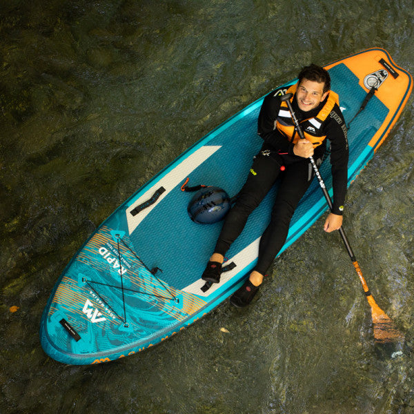 Inflatable Stand-Up Paddleboard - Man sitting on the Aqua Marina Rapid 9'6" Inflatable Stand Up Paddleboard