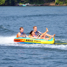 Load image into Gallery viewer, Rave Charger 3P Towable Tube being towed with 3 people riding on it