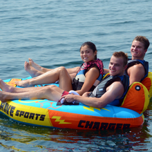 Load image into Gallery viewer, Rave Charger 3P Towable Tube being towed with 3 people riding on it