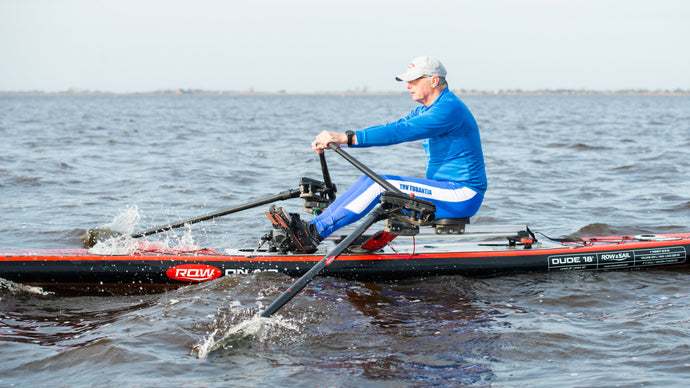 Man rowing on Dude 18' with the ROWONAIR RowVista Universal Rowing Unit