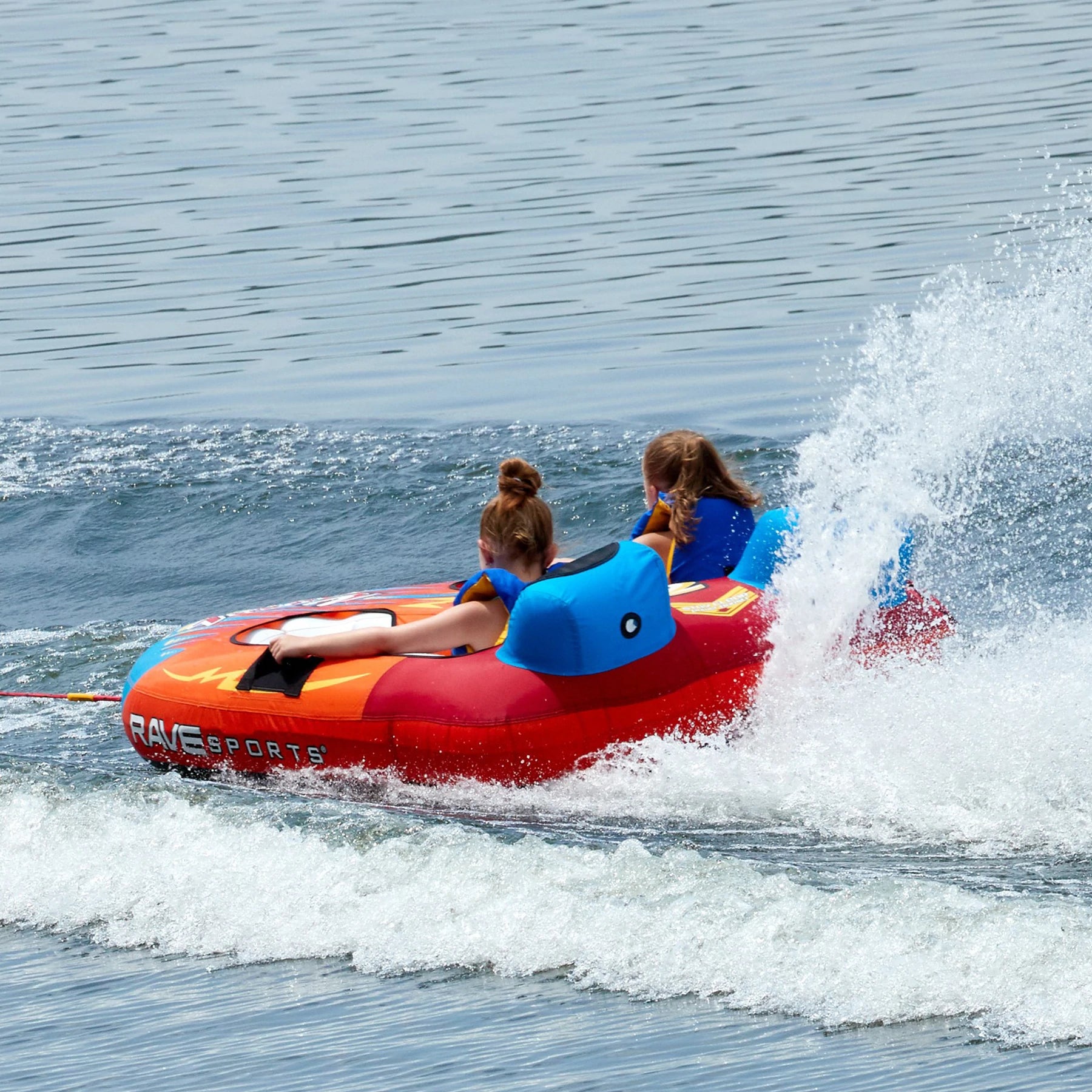 Two kids riding the Rave Sports Tirade II Towables 02371