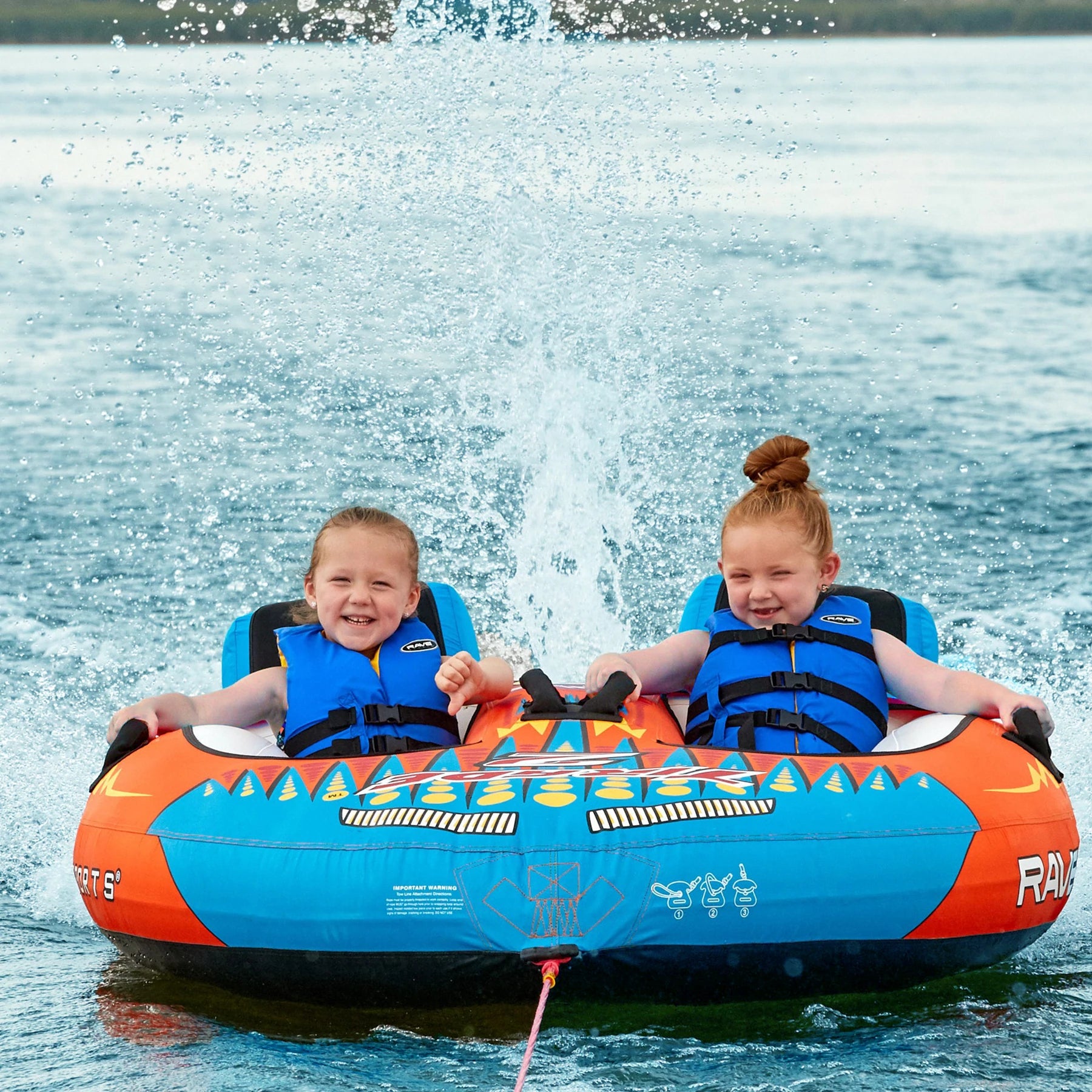 Two kids riding the Rave Sports Tirade II Towables 02371