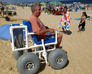 Man On The Beach In A AccessRec PVC Beach Wheelchair