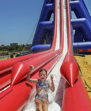 Load image into Gallery viewer, Girl enjoying the fall from the top of the Freestyle Slides Drop Inflatable Water Slide