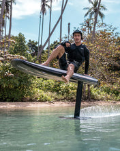 Load image into Gallery viewer, Man sitting on the Awake Vinga 3 Electric Surfboard EFoil