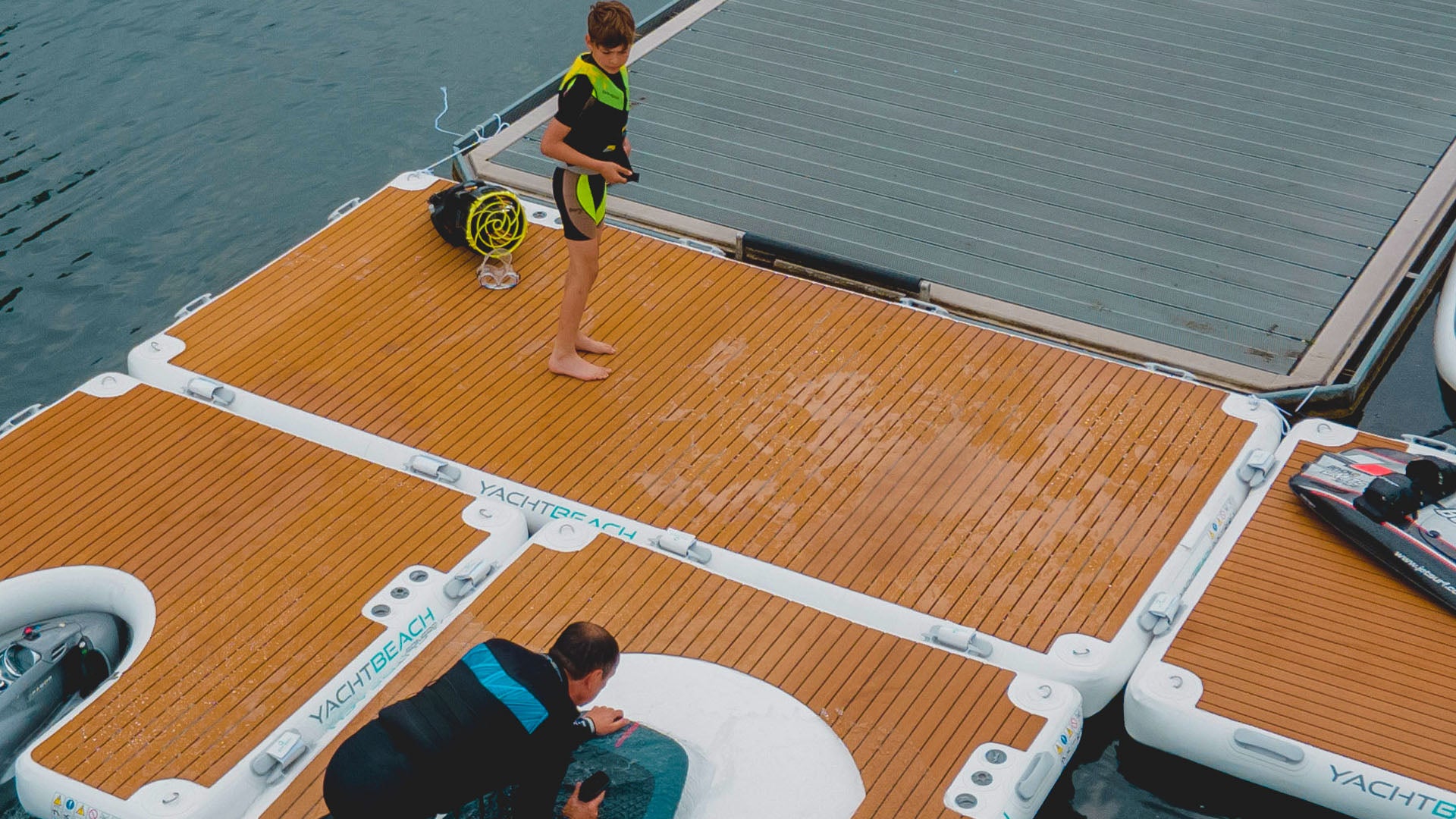 Kid standing on top of Yachtbeach Platform 8.20 Premium Teak 26.9'x6.7' 