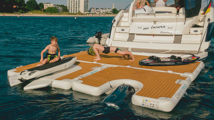 Women having Yoga session on top of Yachtbeach Platform 8.20 Premium Teak 26.9'x6.7'