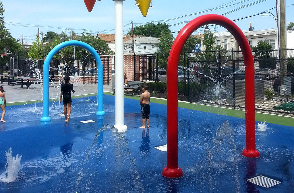 Children Playing On A Splashpad With Rain Drop Prodcts Super Soaker Water Features