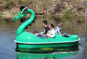 Three people riding the Adventure Glass Dragon Classic 4 Person Paddle Boat
