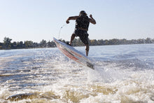 Load image into Gallery viewer, Man enjoying the wave with the SAVA All-New E1-B Electric Surfboard