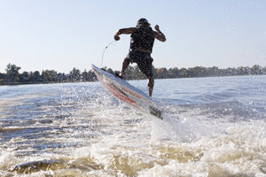 Man enjoying the wave with the SAVA All-New E1-B Electric Surfboard