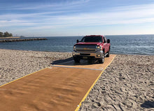 Load image into Gallery viewer, Red Truck Driving Up The Beach On A  AccessRec Mustmove® Vehicle Beach Access Mat 