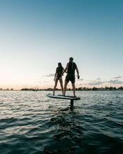 Load image into Gallery viewer, Man and woman boarding the Awake Vinga 3 Electric Surfboard EFoil