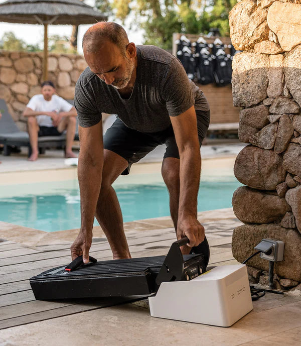 Man charging the Flex Battery to the Awake Flex Battery Charger