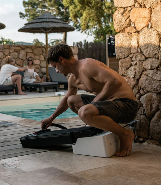 Man charging the Awake Battery to the Awake Flex Battery Charger