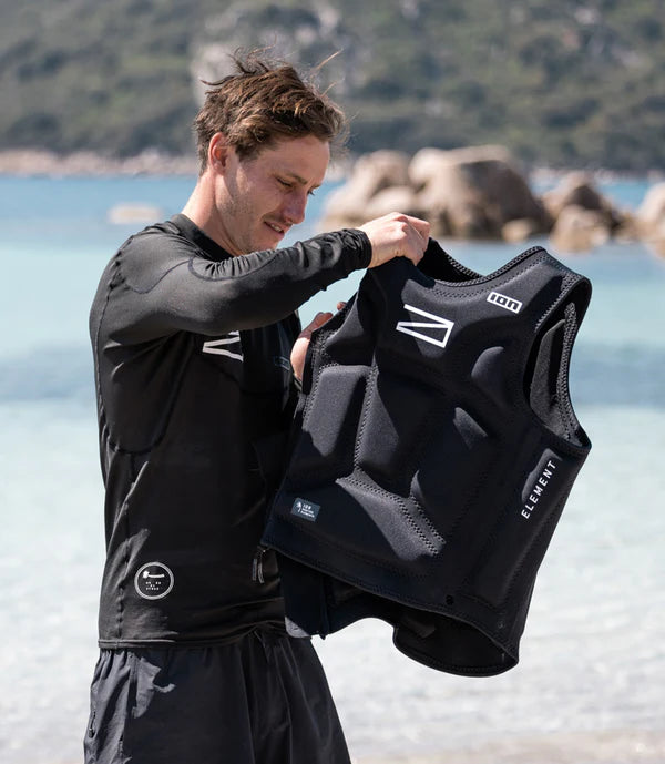 Man preparing to wear the Awake x ION Impact Vest