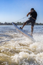 Load image into Gallery viewer, Man having fun on the water with the  SAVA All-New E1-B Electric Surfboard