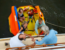 Load image into Gallery viewer, six people preparing to board the Switlik Type II Coastal Passage Raft with Part 91 Kit