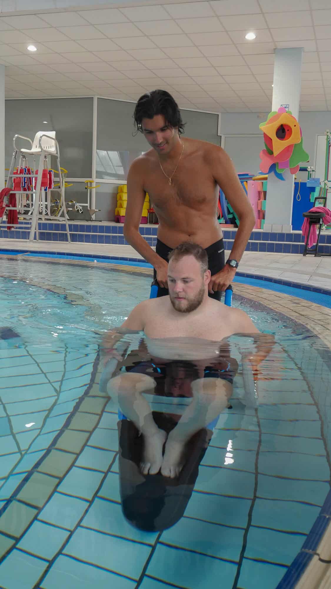 Man in pool in the Hippocampe Pool Wheelchair
