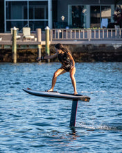 Load image into Gallery viewer, Woman riding the Awake Vinga 3 Electric Surfboard EFoil