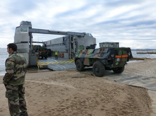 Load image into Gallery viewer, Military Using AccessRec Mustmove® Vehicle Beach Access Mats To Load Their Vehicle From The Sand To A Ferry Boat
