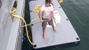 Man on top of Freestyle Slides 13'12" X 6'56" Work Dock while cleaning the boat
