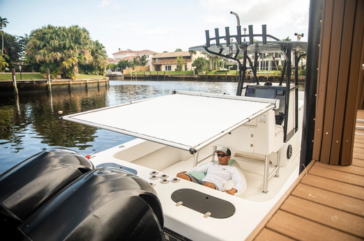 Man enjoying the shade of BocaShade Express Boat Shade