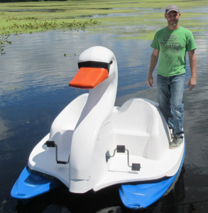Man standing at the side of Adventure Glass Swan Platform 2 Person Paddle Boat