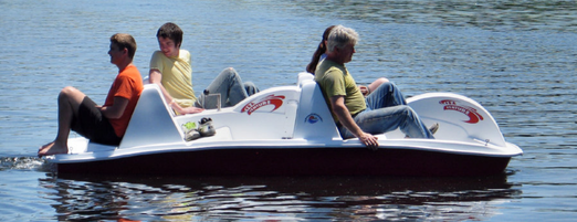 Adventure Glass 6 Person 4 peddler SeaVenture Paddle Boat with a family of four on board