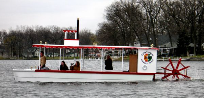 Adventure Glass 20 Person Genuine Sternwheel Riverboat with people enjoying the ride and the view